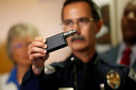 Police Chief Jeff Davis holds up a vape similar to the one held by Alfred Olango after police released video showing the the death of Alfred Olango, who was shot by El Cajon police Tuesday, at the El Cajon Police Department headquarters in El Cajon, California, U.S. September 30, 2016. REUTERS/Patrick T. Fallon/File Photo
