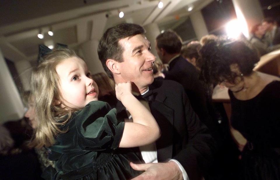 N.C. Attorney General Roy Cooper works the crowd at the his inaugural cocktail party with his 6 year old daughter Clair in January 2001.