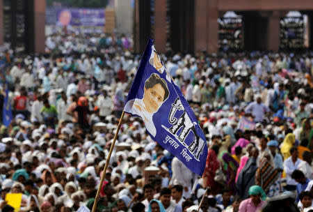 A supporter of Bahujan Samaj Party (BSP) waves a flag featuring the party's chief Mayawati during an election campaign rally on the occasion of the death anniversary of Kanshi Ram, founder of BSP, in Lucknow, India, October 9, 2016. REUTERS/Pawan Kumar