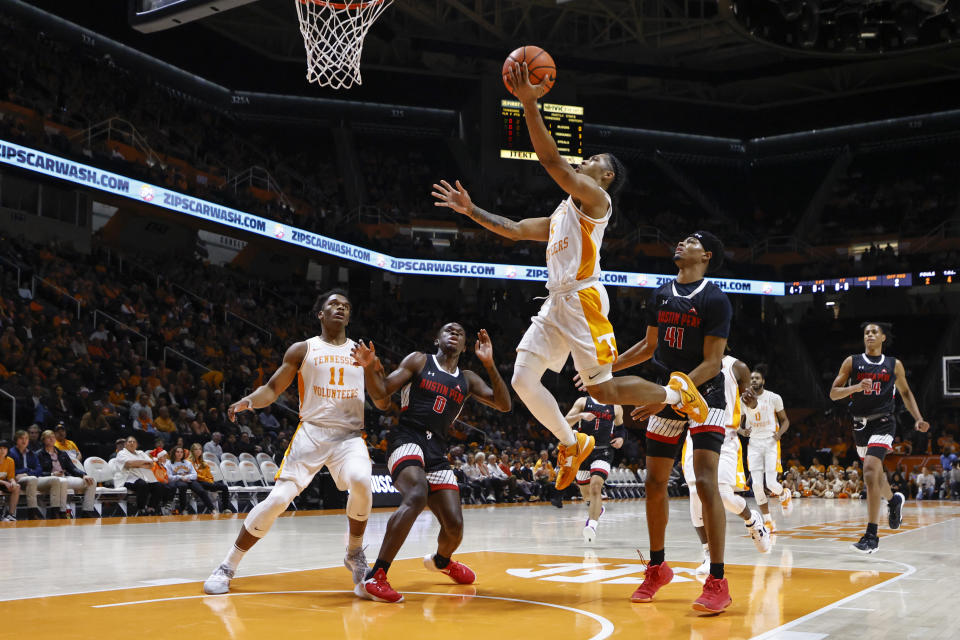 Tennessee guard Zakai Zeigler (5) shoots past Austin Peay guard Cameron Copeland (41) during the first half of an NCAA college basketball game Wednesday, Dec. 21, 2022, in Knoxville, Tenn. (AP Photo/Wade Payne)