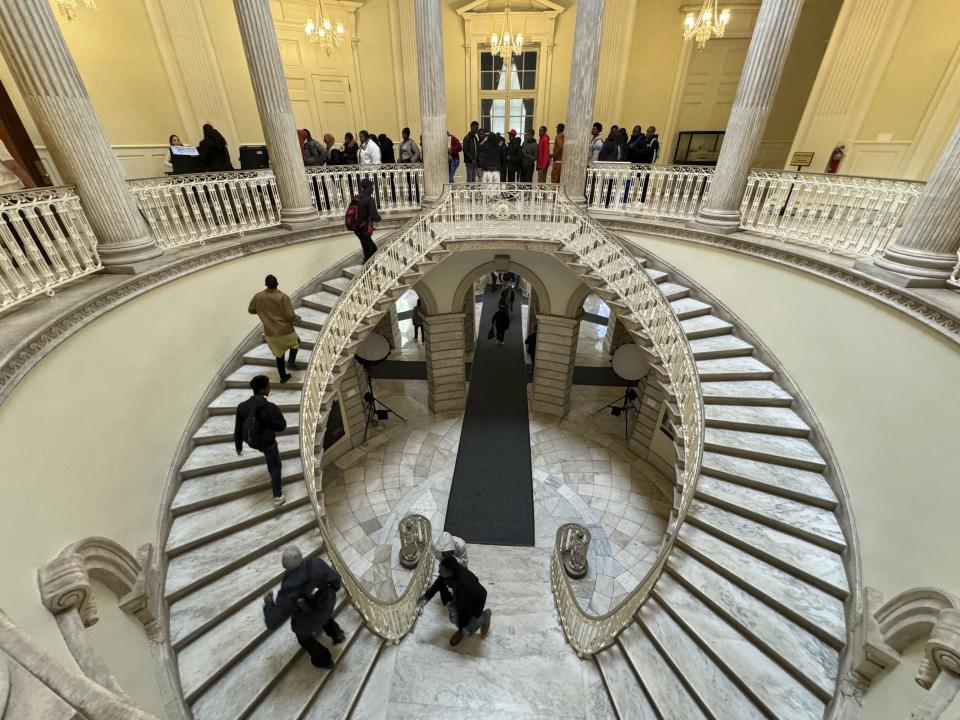 Immigrants line up to attend a city council hearing on disparities in immigration services for Black immigrants at City Hall in New York on Tuesday, April 16, 2024. (AP Photo/Cedar Attanasio)