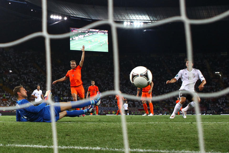 KHARKOV, UKRAINE - JUNE 13: Mario Gomez of Germany scores their first goal past Maarten Stekelenburg of Netherlands during the UEFA EURO 2012 group B match between Netherlands and Germany at Metalist Stadium on June 13, 2012 in Kharkov, Ukraine. (Photo by Julian Finney/Getty Images)