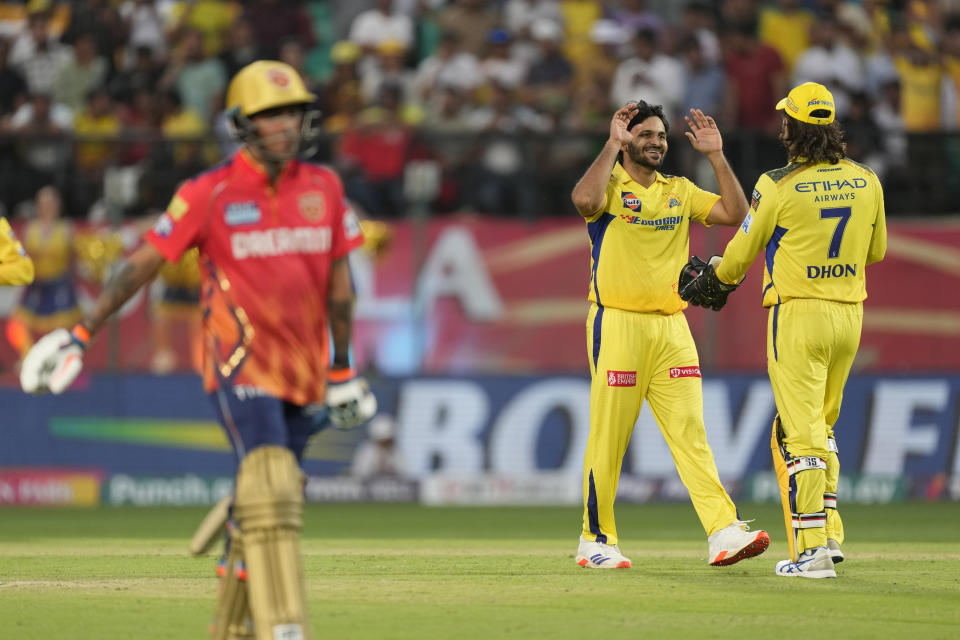 Chennai Super Kings' Shardul Thakur, center, celebrates with teammate MS Dhoni the wicket of Punjab Kings' Rahul Chahar, left, during the Indian Premier League cricket match between Chennai Super Kings and Punjab Kings in Dharamshala, India, Sunday, May 5, 2024. (AP Photo /Ashwini Bhatia)