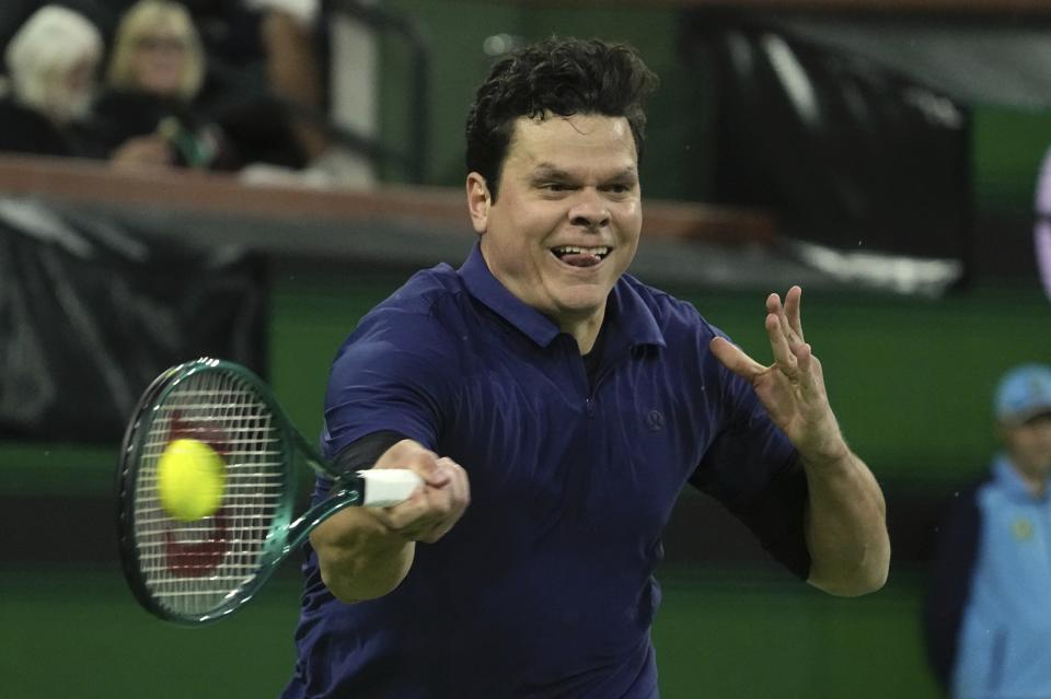 Milos Raonic, of Canada, returns a shot returns a shot to Sumit Nagal, of India, at the BNP Paribas Open tennis tournament Thursday, March 7, 2024, in Indian Wells, Calif. (AP Photo/Mark J. Terrill)