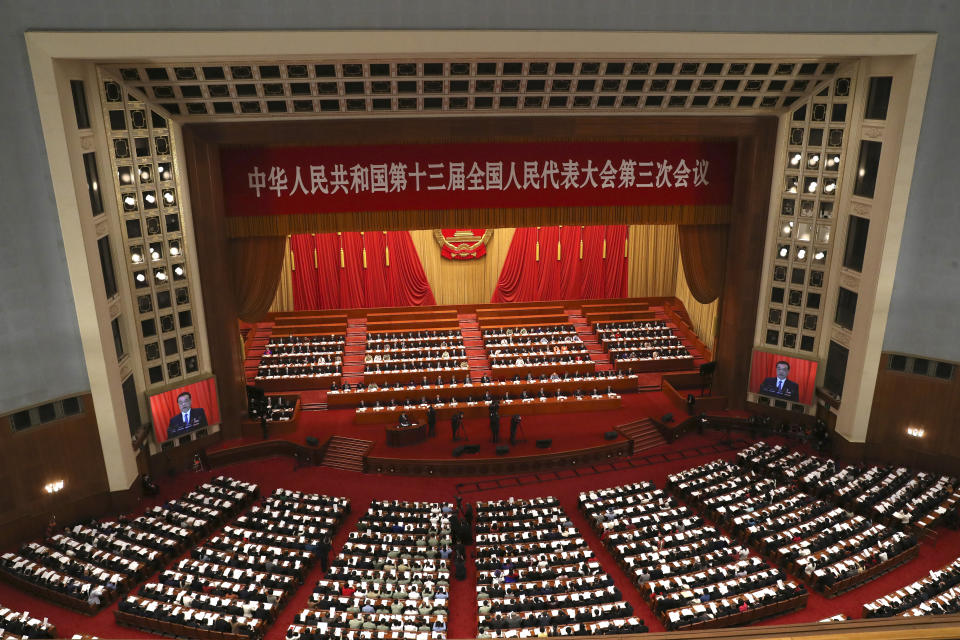 Chinese Premier Li Keqiang delivers the government work report during the opening session of China's National People's Congress (NPC) at the Great Hall of the People in Beijing, Friday, May 22, 2020. (AP Photo/Ng Han Guan, Pool)