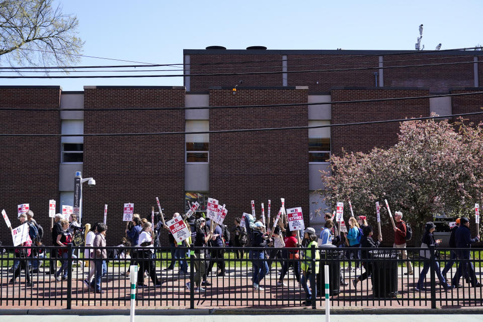 Strikers march in front of Rutgers' buildings in New Brunswick, N.J., Monday, April 10, 2023. Thousands of professors, part-time lecturers and graduate student workers at New Jersey's flagship university have gone on strike — the first such job action in the school's 257-year history. (AP Photo/Seth Wenig)