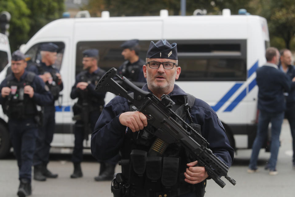 A riot police officer stands guard after a man armed with a knife killed a teacher and wounded two others at a high school in northern France, Friday, Oct. 13, 2023 in Arras. Antiterror prosecutors said they were leading the investigation into the attack at the Gambetta high school in the city of Arras, some 115 miles (185 kilometers) north of Paris. (AP Photo/Michel Spingler)