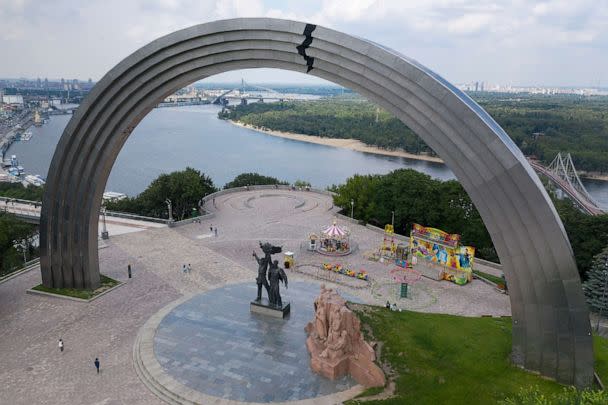 PHOTO: In this June. 23, 2020 file photo people walk in a city park around a Soviet-era monument to Ukraine and Russia's friendship in Kyiv, Ukraine. (Efrem Lukatsky/AP, FILE)