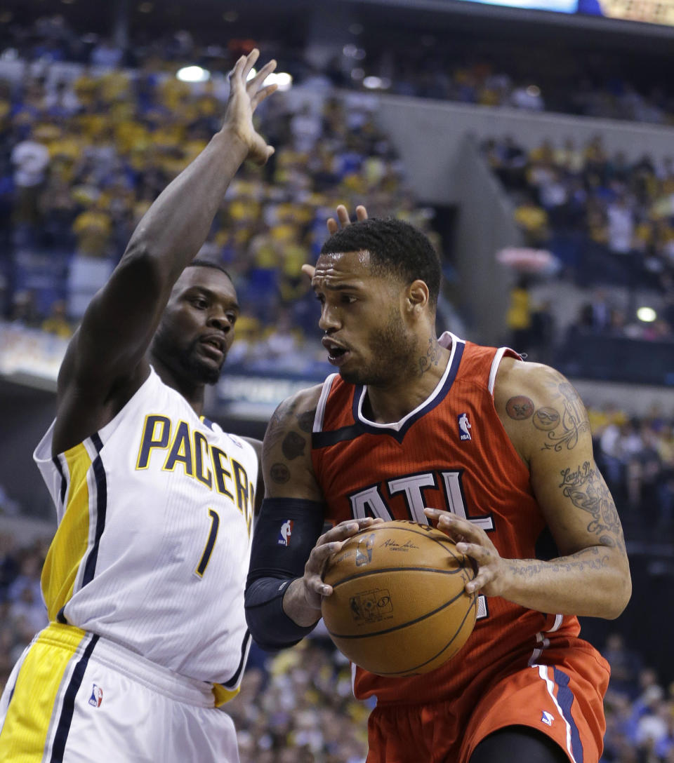 Atlanta Hawks' Mike Scott (32) goes to the basket against Indiana Pacers' Lance Stephenson (1) during the first half in Game 5 of an opening-round NBA basketball playoff series Monday, April 28, 2014, in Indianapolis. (AP Photo/Darron Cummings)