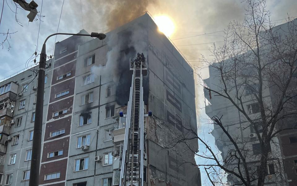 Rescuers work at a site of a residential building damaged by a Russian missile strike, amid Russia's attack on Ukraine, in Zaporizhzhia - REUTERS/Sergiy Chalyi