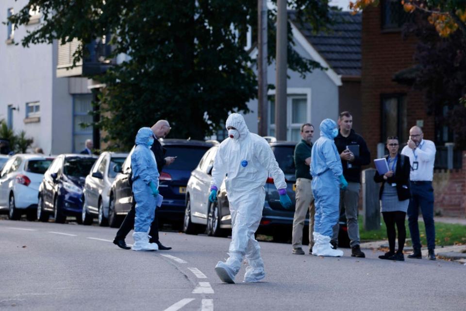 Police forensics officers work at the scene (AFP/Getty)