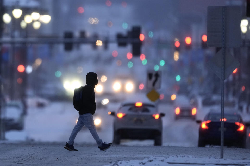 A pedestrian braves sub-zero temperatures while walking Monday, Jan. 15, 2024, in downtown Kansas City, Mo. (AP Photo/Charlie Riedel)