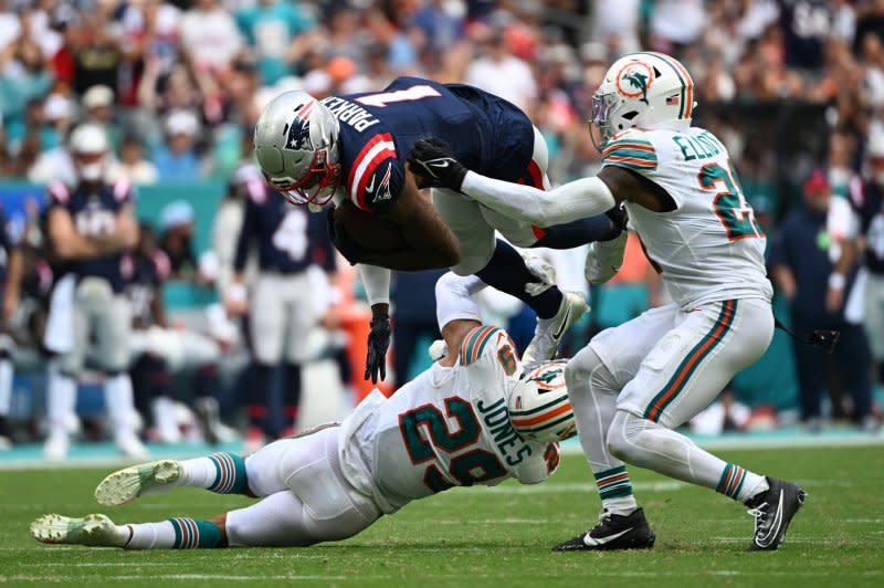 New England Patriots wide receiver DeVante Parker (C) takes a hit during a game against the Miami Dolphins on Sunday at Hard Rock Stadium in Miami Gardens, Fla. Photo by Larry Marano/UPI