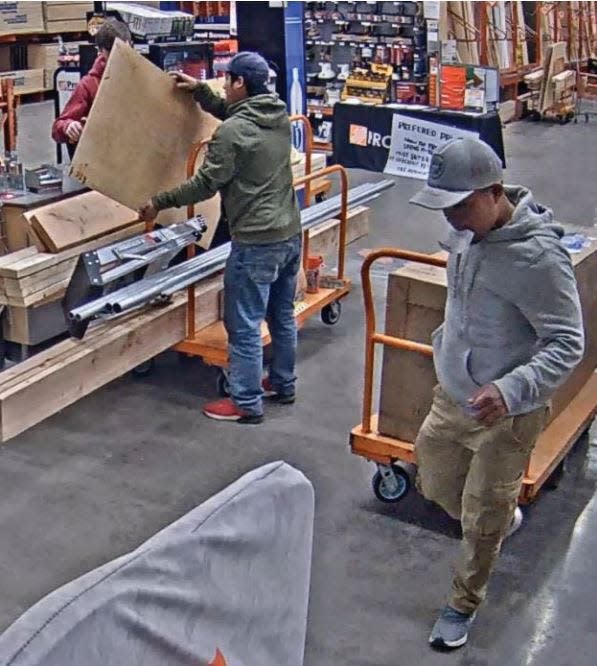 The two Guatemalan men in this picture conspired in the theft of 184 spools of wire from The Home Depot in Warwick in April 2023, according to a federal agent's affidavit. Here, one of the men appears to shield a cashier's view as the other man rolls through with a box holding stolen wire, says the affidavit.