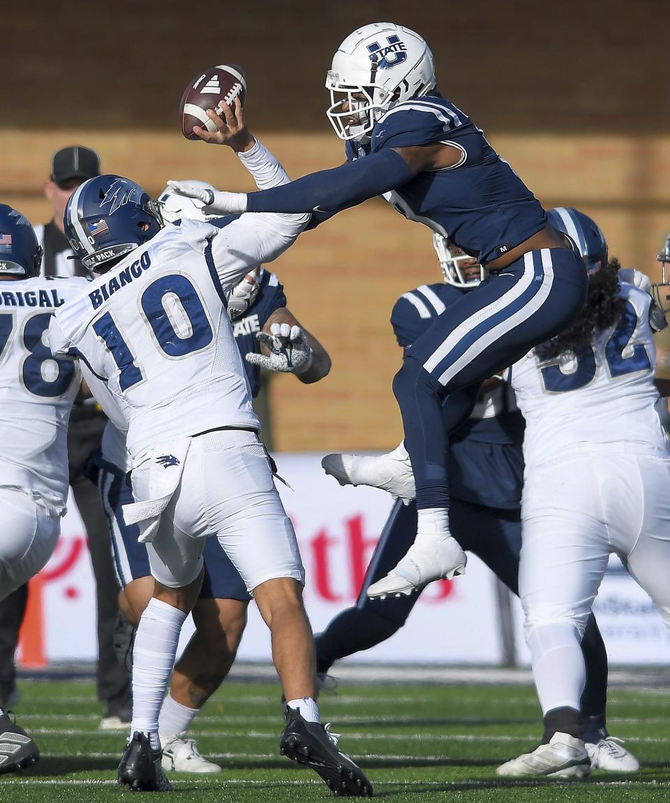 Nevada quarterback AJ Bianco (10) throws the ball as Utah State linebacker Anthony Switzer, right, defends during the first half of an NCAA college football game Saturday, Nov. 11, 2023, in Logan, Utah. | Eli Lucero/The Herald Journal via AP