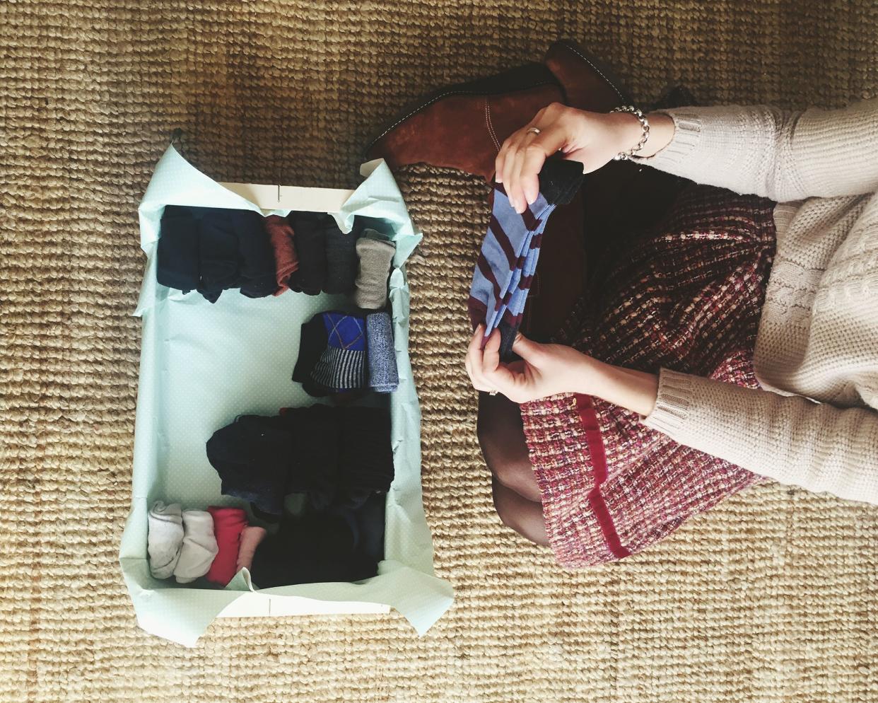 high angle view of woman folding socks