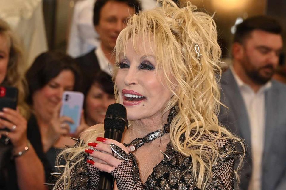 <p>AFF-USA/Shutterstock </p> Dolly Parton attends the ribbon cutting for her 