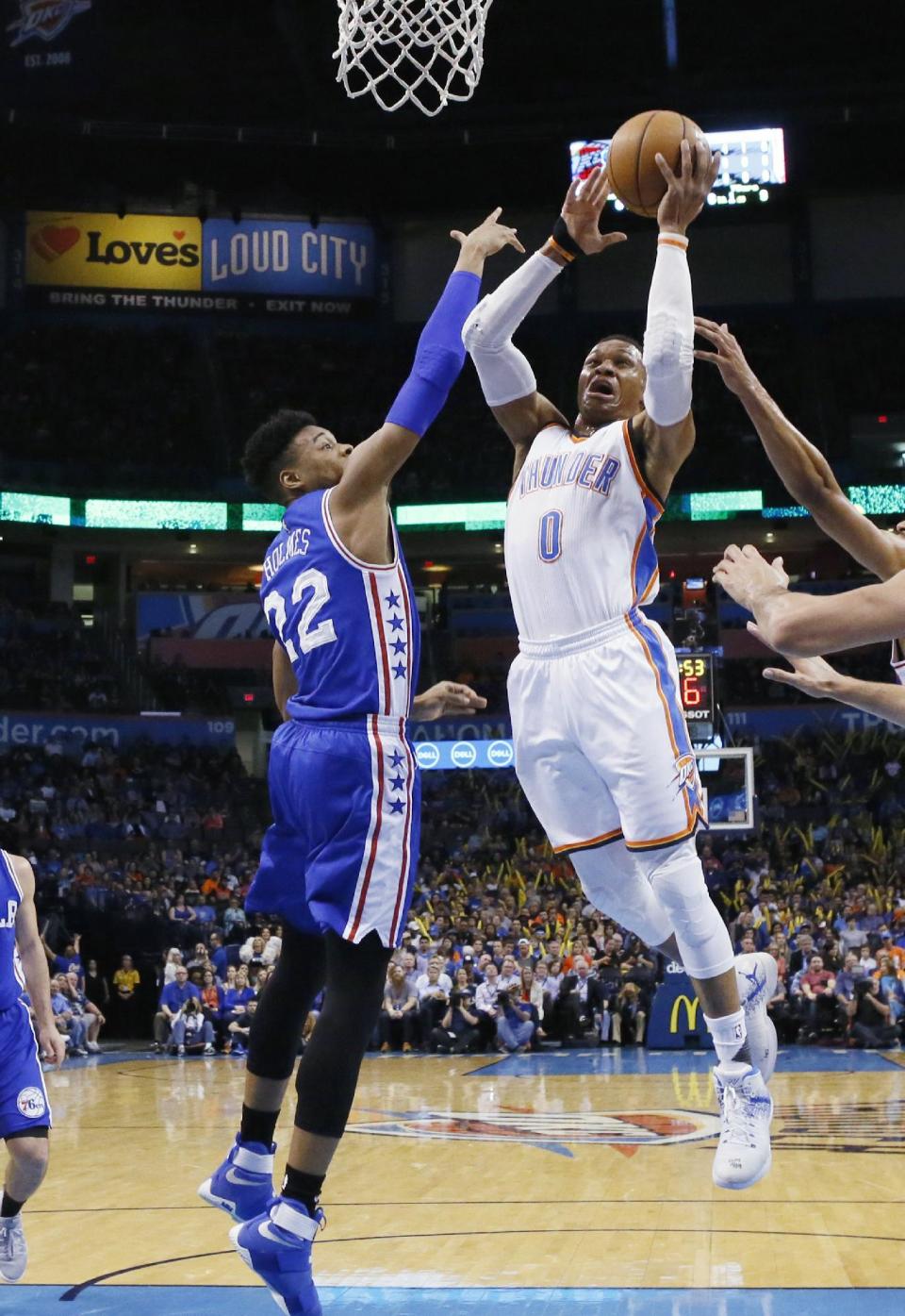 Oklahoma City Thunder guard Russell Westbrook (0) shoots in front of Philadelphia 76ers forward Richaun Holmes (22) during the first quarter of an NBA basketball game in Oklahoma City, Wednesday, March 22, 2017. (AP Photo/Sue Ogrocki)