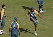 Pakistan's skipper Babar Azam, center, kicks a soccer ball during a practice session at National Stadium in Karachi, Pakistan, Monday, Jan. 25, 2021. Pakistan will play the first test match against South Africa on Jan. 26. (AP Photo/Fareed Khan)