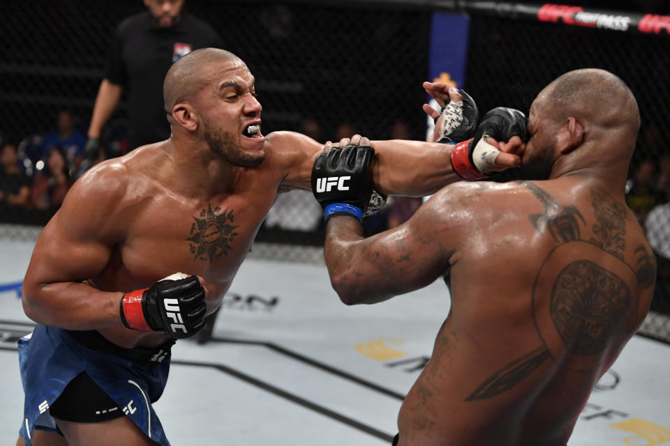 SINGAPORE, SINGAPORE - OCTOBER 26: (L-R) Ciryl Gane of France punches Don'Tale Mayes in their heavyweight bout during the UFC Fight Night event at Singapore Indoor Stadium on October 26, 2019 in Singapore. (Photo by Jeff Bottari/Zuffa LLC via Getty Images)