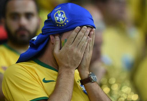 Brazilian fan react during the semi-final match between Brazil and Germany at the Mineirao Stadium in Belo Horizonte during the 2014 FIFA World Cup on July 8, 2014