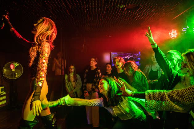 Members of the audience reach for drag queen Adele during a drag show in Kyiv, Ukraine.