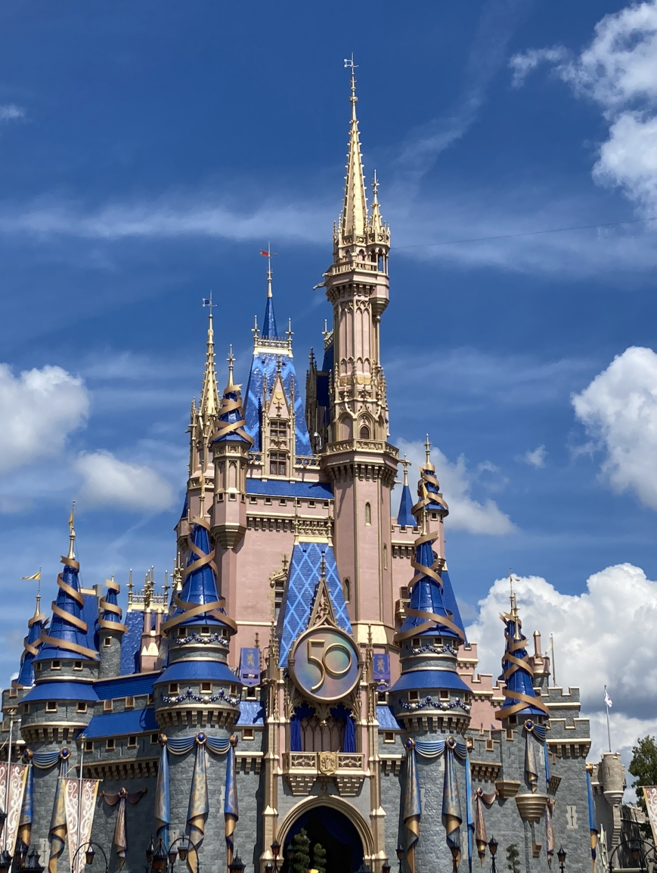Disney's Cinderella Castle adorned with a "50" emblem for the anniversary celebration