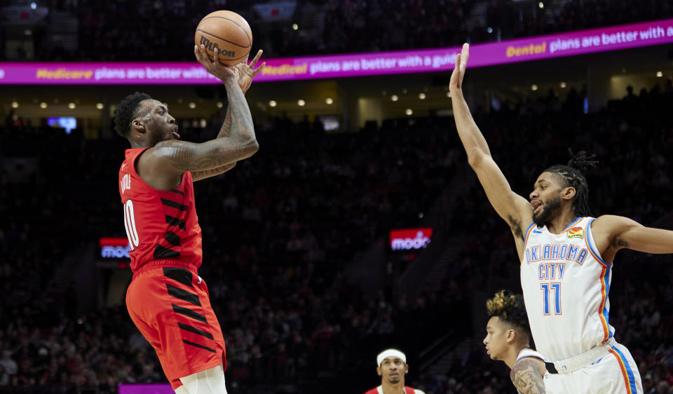 Portland Trail Blazers forward Nassir Little, left, looks to shoot over Oklahoma City Thunder guard Isaiah Joe during the second half of an NBA basketball game in Portland, Ore., Sunday, March 26, 2023. (AP Photo/Craig Mitchelldyer)