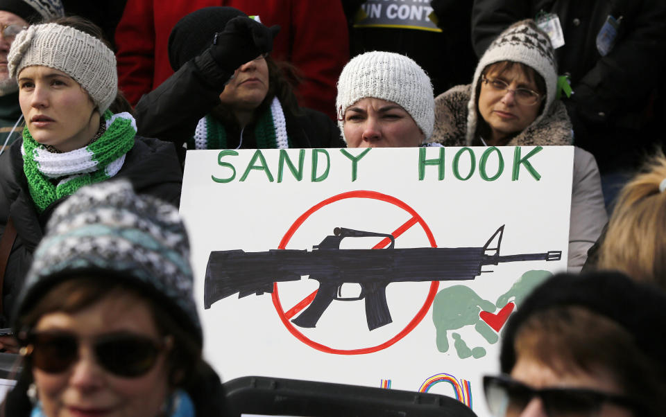 People participating in the March on Washington for Gun Control in 2013 hold signs memorializing those killed at Sandy Hook Elementary School in 2012. (Photo: Jonathan Ernst / Reuters)