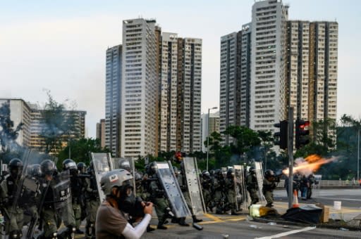 Hong Kong police fire tear gas at protesters in Tai Po district, one of at least 11 locations where they battled to disperse protesters in the most widespread unrest during two months of demonstrations