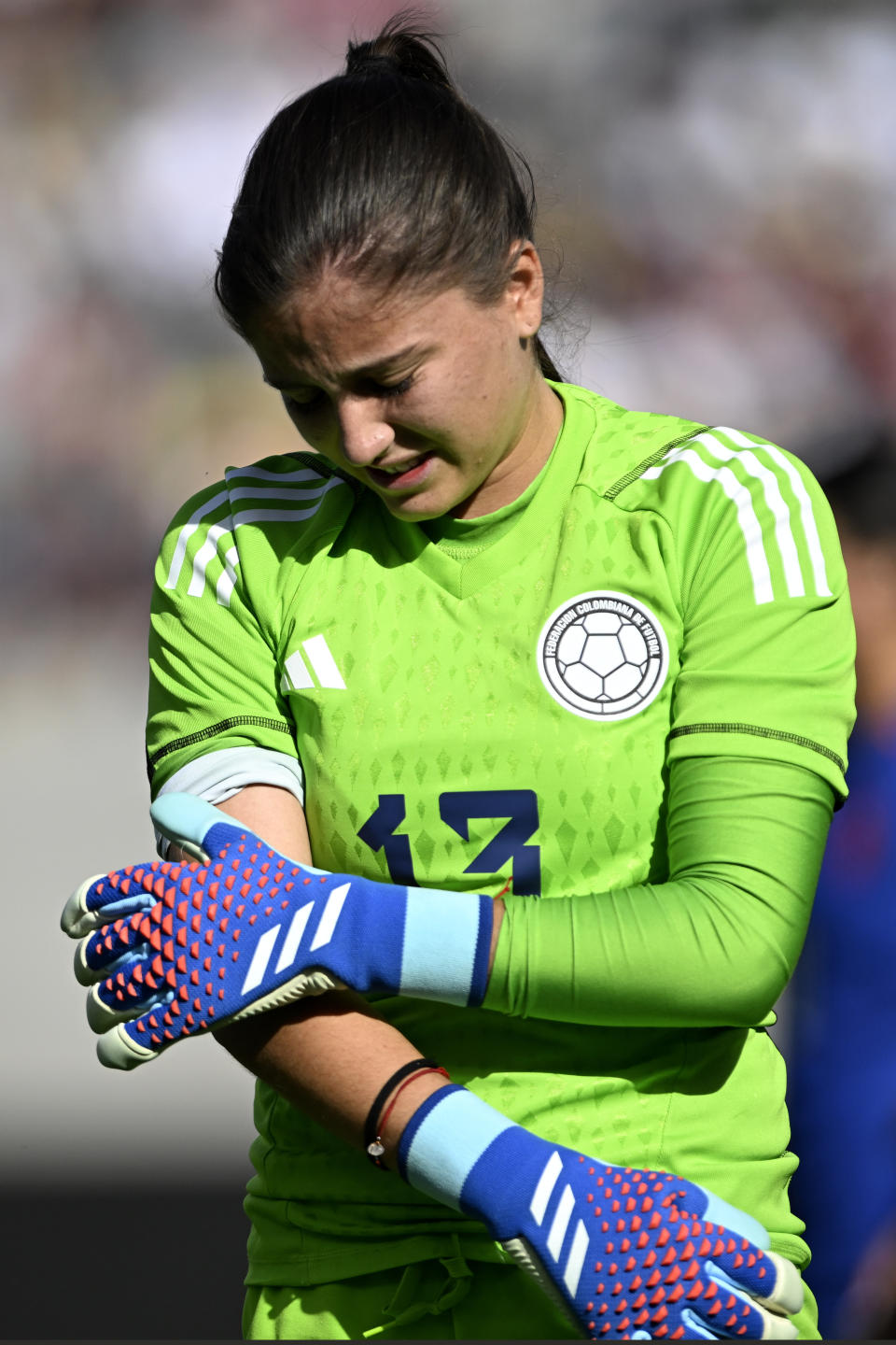 Colombia goalkeeper Natalia Giraldo exits with an injury after taking a shot from United States forward Alex Morgan during the first half of an international friendly soccer match Sunday, Oct. 29, 2023, in San Diego. (AP Photo/Alex Gallardo)