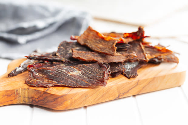<p><a href="https://www.gettyimages.com/detail/photo/beef-jerky-meat-dried-sliced-meat-on-wooden-cutting-royalty-free-image/1401471831?phrase=beef+jerky&adppopup=true" rel="nofollow noopener" target="_blank" data-ylk="slk:jirkaejc/Getty Images;elm:context_link;itc:0;sec:content-canvas" class="link ">jirkaejc/Getty Images</a></p>