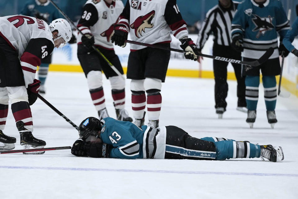 San Jose Sharks left wing John Leonard (43) lies on the ice after colliding with the boards during the first period against the Arizona Coyotes in an NHL hockey game Friday, May 7, 2021, in San Jose, Calif. (AP Photo/Tony Avelar)