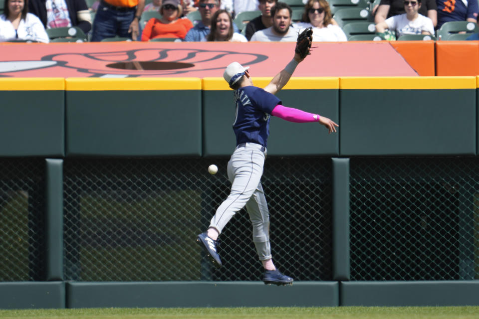 Seattle Mariners' left fielder Sam Haggerty (0) can't reach a Detroit Tigers' Akil Baddoo fly ball in the sixth inning of a baseball game, Sunday, May 14, 2023, in Detroit. (AP Photo/Paul Sancya)
