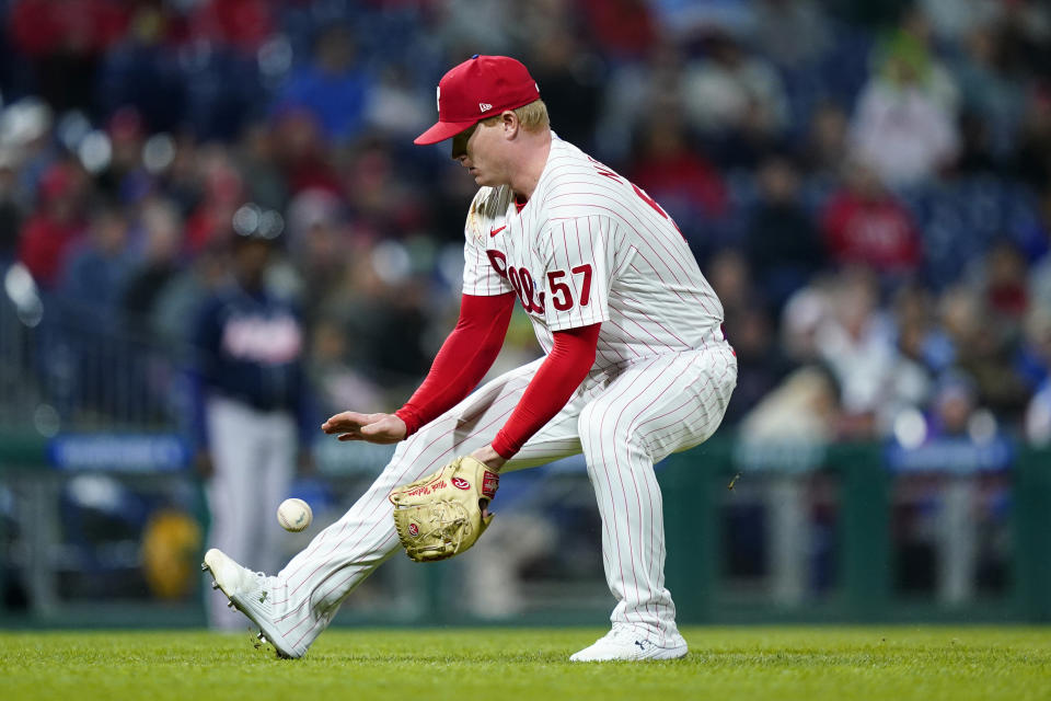 Philadelphia Phillies pitcher Nick Nelson fields a ground pout by Atlanta Braves' Austin Riley during the eighth inning of a baseball game, Friday, Sept. 23, 2022, in Philadelphia. (AP Photo/Matt Slocum)