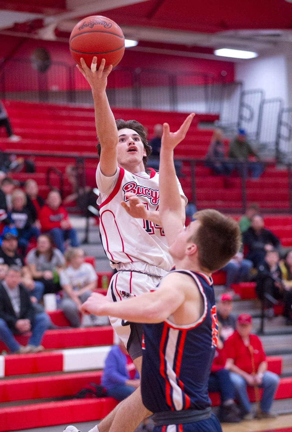 Bucyrus' Kavan Combs attempts a basket over Galion's Steven Glew.