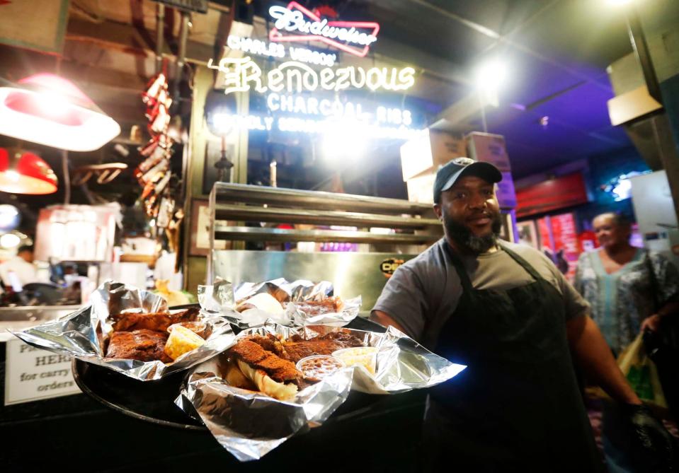 Darrin Howse holds a tray of ribs inside The Rendezvous in Downtown Memphis on Sept. 26, 2023.  The Rendezvous is among the restaurants participating in Downtown Dining Week.