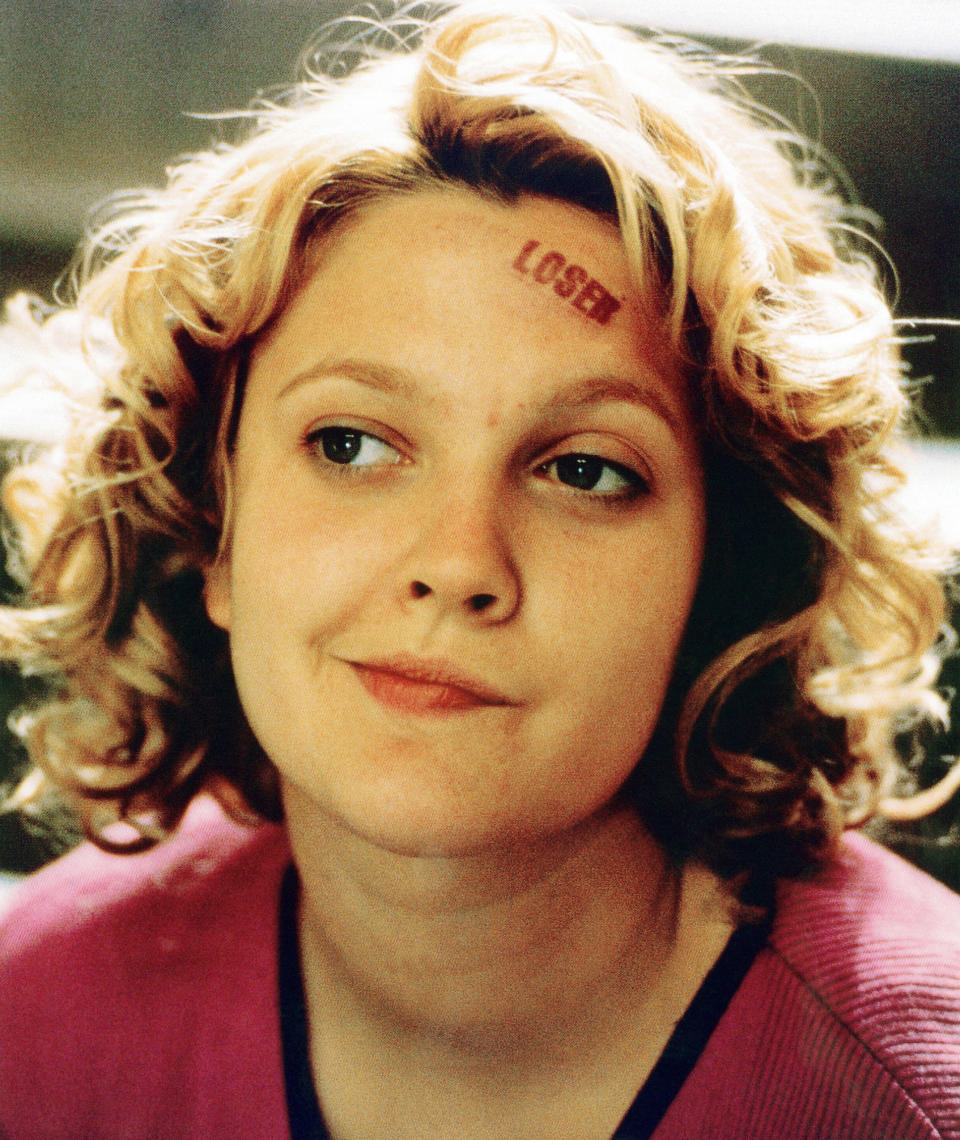 Drew Barrymore with the word "LOSER" stamped on her forehead in a scene from "Never Been Kissed."