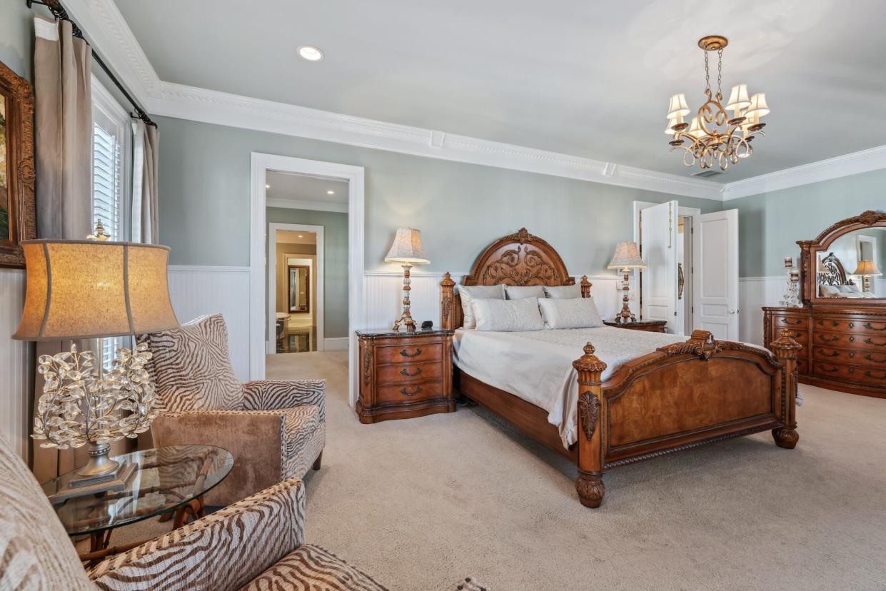 A large bedroom with an attached closet and bathroom.