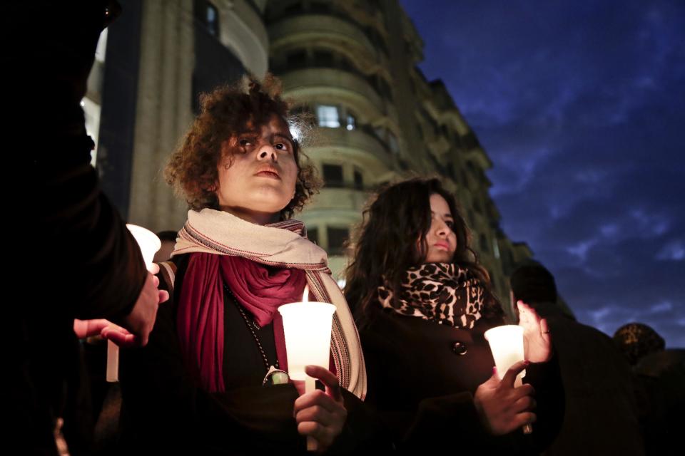 People hold candles during a vigil for victims of a Sunday bombing at a Coptic cathedral, in downtown Cairo, Egypt, Wednesday, Dec. 14, 2016. Twenty five Christians were killed at the city's main Coptic cathedral in what was one of the deadliest attacks on the religious minority in recent memory. The bomb went off while worshippers were attending Sunday Mass at a chapel adjacent to St. Mark's Cathedral. (AP Photo/Nariman El-Mofty)