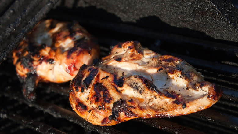 charred chicken breast on grill