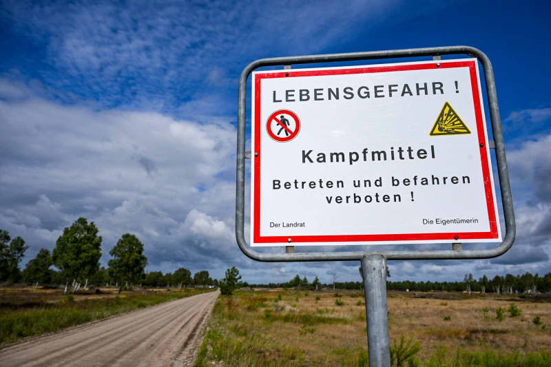 A sign reading "Danger of death! Explosive ordenance, do not enter," marks the area in Germany's Kyritz-Ruppiner Heide heathland, where explosive ordnance recovery is being carried out on a former military training area. Jens Kalaene/dpa