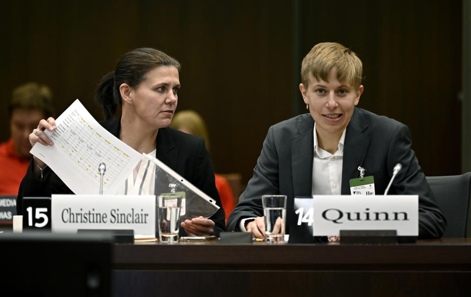 Canadian national soccer team players Christine Sinclair, left, and Quinn prepare to appear before the Standing Committee on Canadian Heritage in Ottawa, studying safe sport in Canada, Thursday, March 9, 2023. (Justin Tang/The Canadian Press via AP)