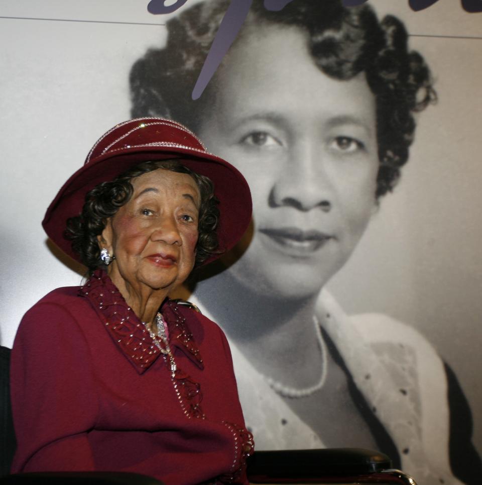 In this March 14, 2008, file photo, Dorothy Height, who served as president of the National Council of Negro Women for 40 years until 1997, sits in front of her featured story board inside the "Freedom's Sisters" exhibition at the Cincinnati Museum Center in Cincinnati.