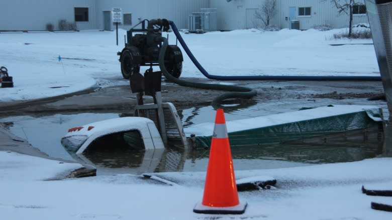 Pickup truck swallowed by sinkhole after water main break