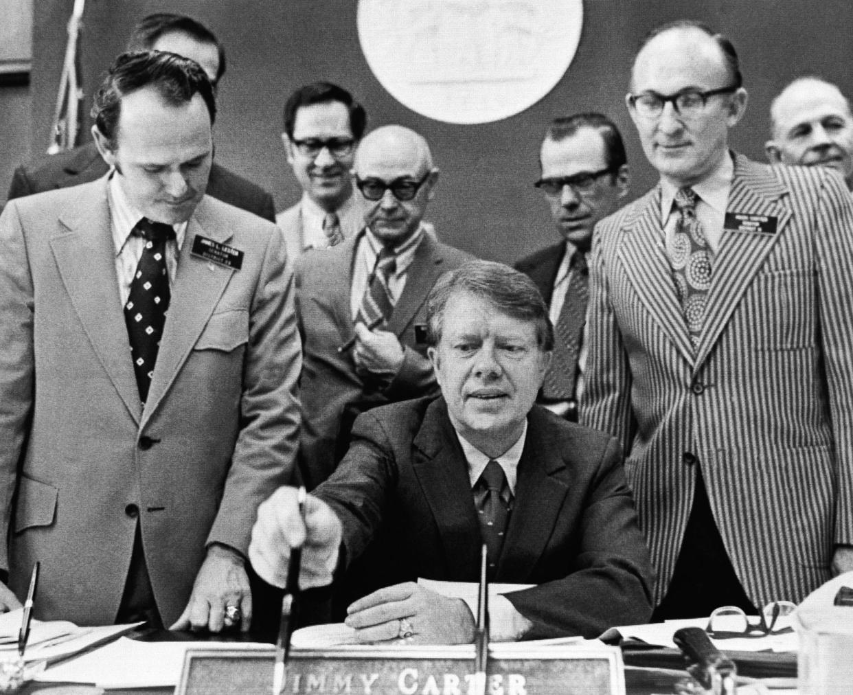 Gov. Jimmy Carter prepares to sign a Georgia Senate House resolution opposing forced busing to achieve integration in the classrooms of the U.S. on Feb. 25, 1972, in Atlanta.