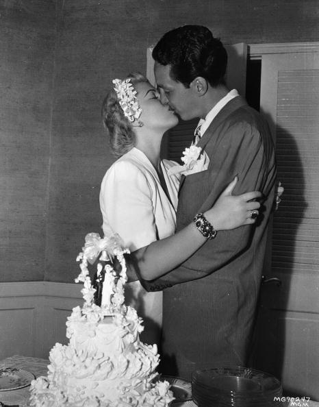 <p>Lana Turner seals her matrimony to second husband, Steve Crane, with a kiss in front of their wedding cake—although the couple would eventually divorce, marry, and divorce again. They welcomed their daughter, Cheryl Crane, in 1943. </p>