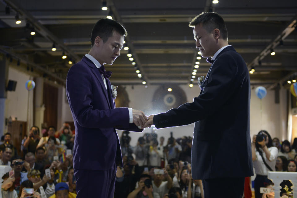 <p>Sun Wenlin, left, and his partner, Hu Mingliang, during their wedding ceremony in the city of Changsha, Hunan province, China, on May 17, 2016. The couple held a wedding ceremony after they sued the city’s civil affairs bureau and lost a lawsuit because they wished to formalize their marriage. The city’s government office has rejected their marriage registration application. China does not recognize same-sex marriages nor same-sex civil partnerships. (Stringer/EPA) </p>