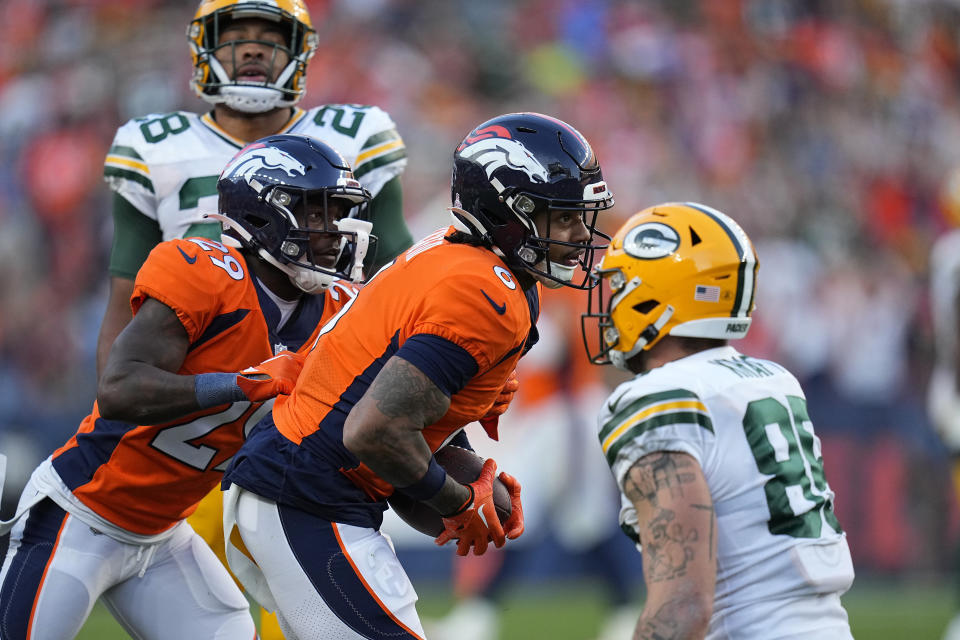 Denver Broncos safety P.J. Locke, middle, reacts after intercepting a pass against the Green Bay Packers during the second half of an NFL football game in Denver, Sunday, Oct. 22, 2023. (AP Photo/Jack Dempsey)