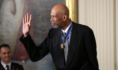 FILE PHOTO: Retired NBA basketball Hall of Fame player Kareem Abdul-Jabbar waves after receiving the Presidential Medal of Freedom during a ceremony in the White House East Room in Washington, DC, U.S. on November 22, 2016. REUTERS/Carlos Barria/File Photo